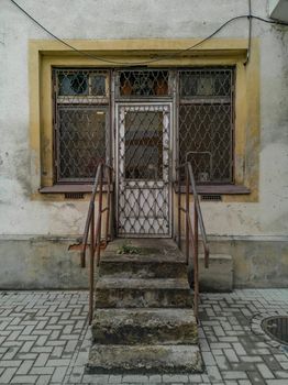 Few old stone stairs to entrance to old closed shop