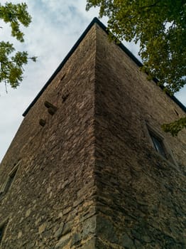Upward view to old stone tower building in Siedlecin village