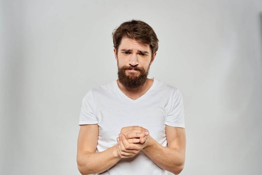 Bearded man gesturing with hand white cropped t-shirt studio lifestyle. High quality photo