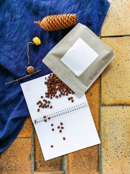 Pack of Coffee beans wheat cone and flowers lay on floor and cloth