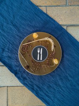 Coffee beans wheat and flowers lay on metal plate with fork and knife sign