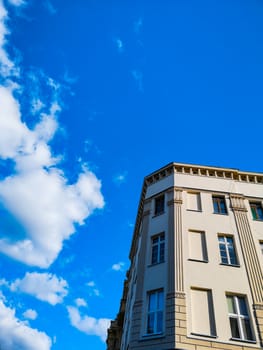 Old renovated tenement house at sunny cloudy day