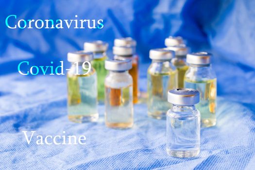 Corona virus and Covid - 19 new vaccine in ampules, different color variations of vaccine on the blue background
