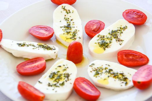 italian appetizer mozzarella cherry tomatoes oregano and oil