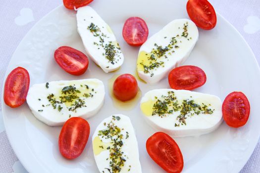 italian appetizer mozzarella cherry tomatoes oregano and oil