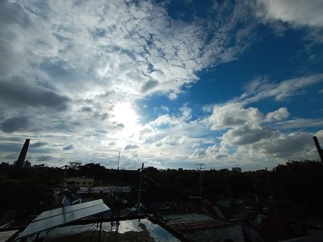 white cloud on blue sky with city