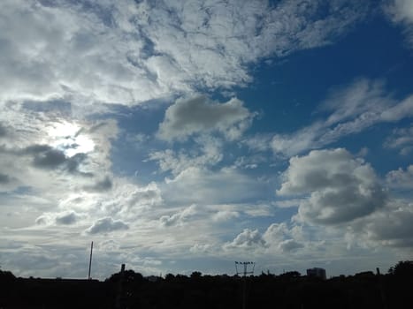 white cloud on blue sky with city