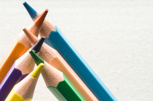 A group of colorful pencils in white background with text space