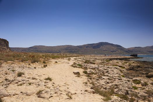 GRAMVOUSA - BALOS, THE CRETE ISLAND, GREECE - JUNE 4, 2019: People on the beach of Balos.