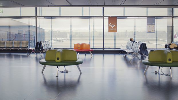 Vienna, Vienna/Austria - November 2nd 2020: Passengers waiting at Vienna airport. Only a few people travelling and a lot of closed gates.