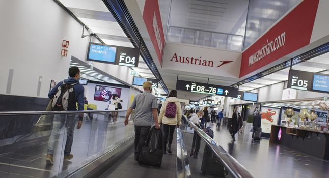 Vienna, Vienna/Austria - November 2nd 2020: Passengers walking to departure gates at Vienna airport. Only a few people travelling and a lot of closed gates.