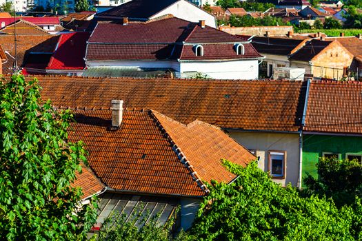 Overview of tile rooftops of old houses. Old buildings architecture.