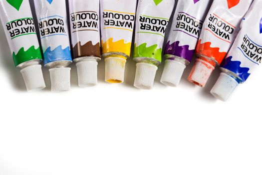 Dried watercolor paints in tubes isolated on white background.