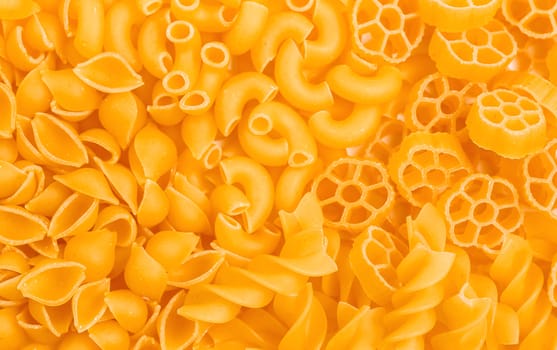 Variety of types and shapes of Italian pasta on the table. Top view.