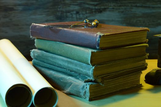 A view of the workspace of an intellectual designer with old books and papers.