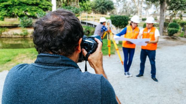 The photographer takes a photo of a group of engineers looking at a plane