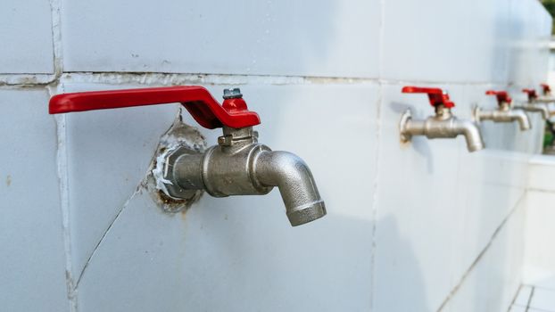 Steel spout installed on a wall with tile