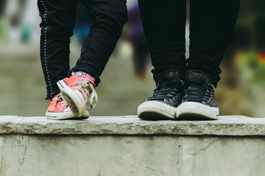 Cropped image of mother and daughter, mom and daughter slippers