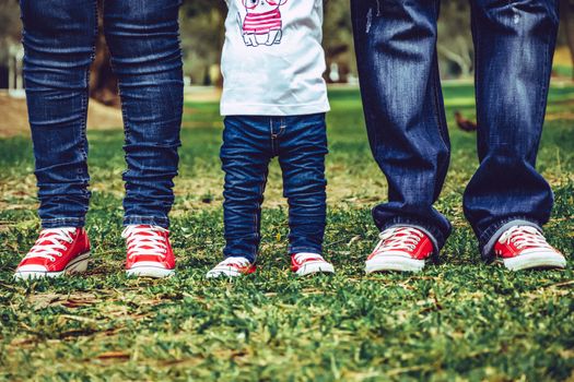 Beautiful young family. Legs of mother, daughter and father