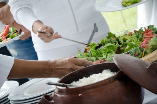 Clay pots with white rice and vegetable salad