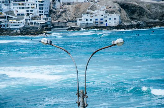 Lamp post on the beach, rusty by the sea breeze