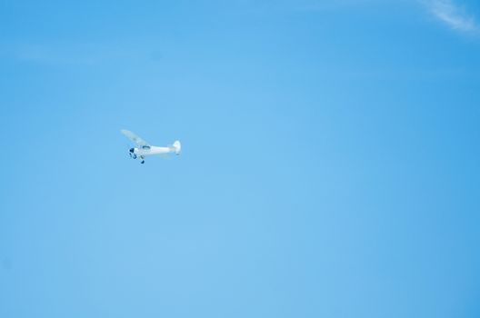 A small plane sailing through the blue skies