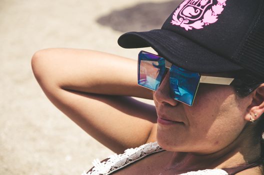 Colorful portrait of young attractive woman wearing sunglasses. Summer beauty concept