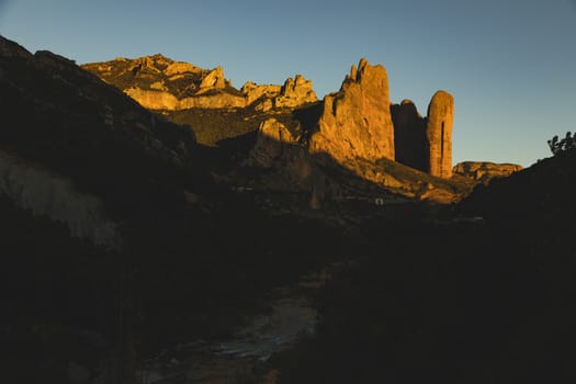 Mountains of the Mallos de Riglos, vertical rock walls at sunset, a famous place for climbing near the Gallego river, in the pre-Pyrenees, Huesca province, Aragon, Spain.