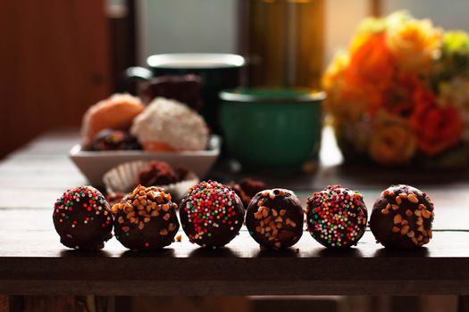 Colorful chocolate and donuts on the table.