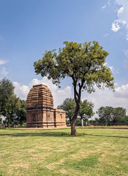 Ancient stone temple monument & tree at Pattadakal , Karnataka, India.
