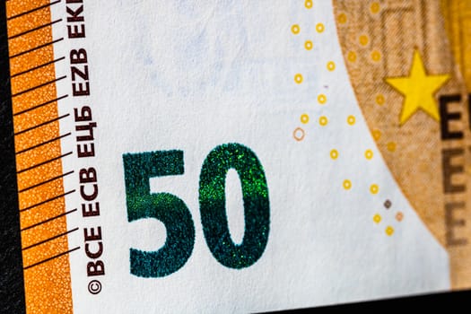 Selective focus on detail of euro banknotes. Close up macro detail of money banknotes, 50 euro isolated. World money concept, inflation and economy concept