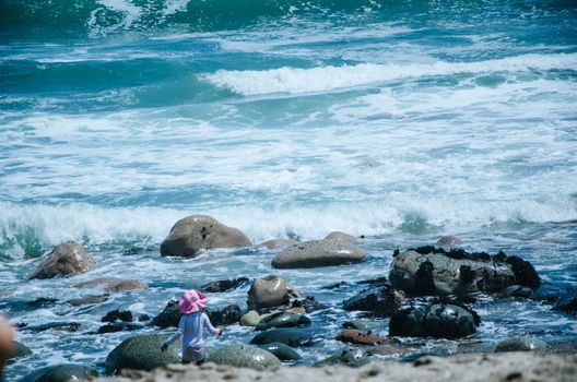 Boy playing on the seashore, summer vacation