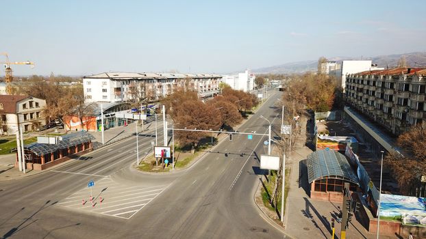 Spring city of Almaty during the quarantine period. Few people on the street, almost no cars. Transport is not running, and a strict quarantine has been imposed. Yellow trees without leaves.