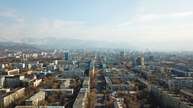 Spring city of Almaty during the quarantine period. Few people on the street, almost no cars. Transport is not running, and a strict quarantine has been imposed. Yellow trees without leaves.