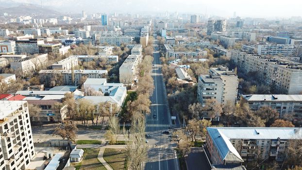 Spring city of Almaty during the quarantine period. Few people on the street, almost no cars. Transport is not running, and a strict quarantine has been imposed. Yellow trees without leaves.