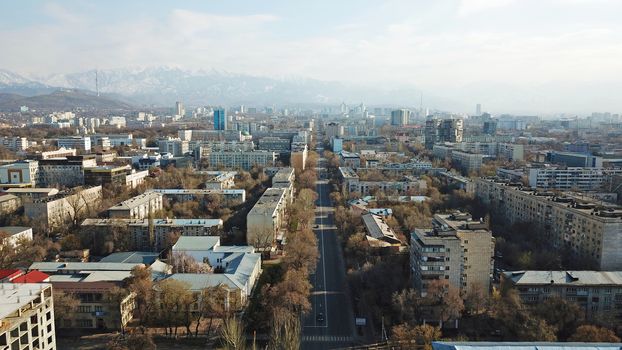 Spring city of Almaty during the quarantine period. Few people on the street, almost no cars. Transport is not running, and a strict quarantine has been imposed. Yellow trees without leaves.