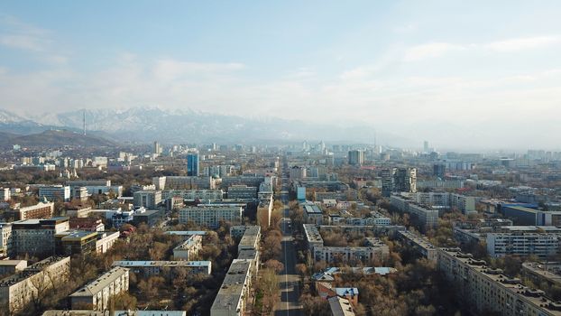 Spring city of Almaty during the quarantine period. Few people on the street, almost no cars. Transport is not running, and a strict quarantine has been imposed. Yellow trees without leaves.