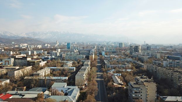 Spring city of Almaty during the quarantine period. Few people on the street, almost no cars. Transport is not running, and a strict quarantine has been imposed. Yellow trees without leaves.