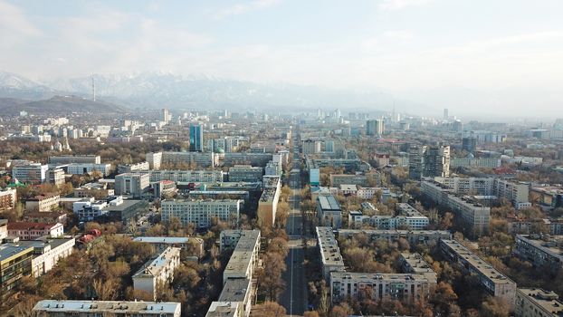 Spring city of Almaty during the quarantine period. Few people on the street, almost no cars. Transport is not running, and a strict quarantine has been imposed. Yellow trees without leaves.