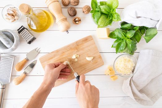 Italian Cuisine. Step by step cooking italian pesto sauce. Step 4 - cutting garlic