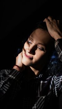 Light and shadow portrait. Beautiful young woman with a shadow pattern on the face in the form of stripes