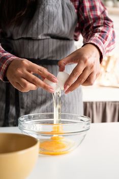 Cooking and baking. Woman hands beating the egg for cooking