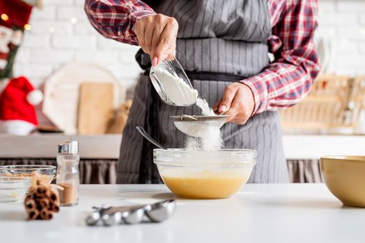 Cooking and baking. Young latin woman pouring flour to the dough cooking at the kitchen