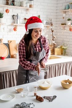 Cooking and baking. Young latin woman pouring flour to the dough cooking at the kitchen