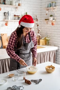 Cooking and baking. Young latin woman mixing dough cooking at the kitchen