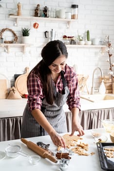 Cooking and baking. Young brunette woman baking cookies at the kitchen