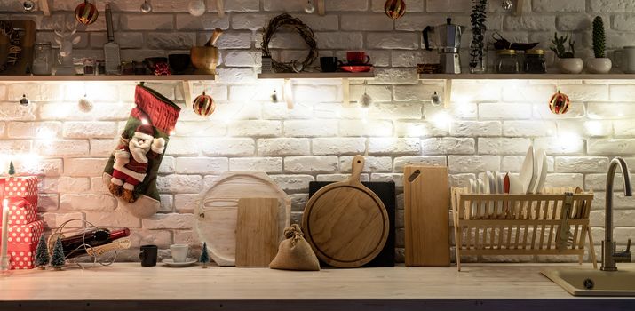 Interior light grey kitchen and red christmas decor. Festive kitchen in Christmas decorations, front view