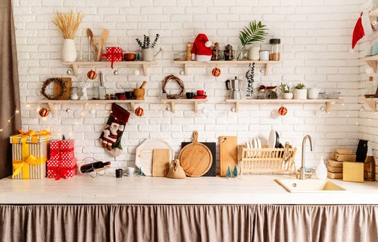 Interior light grey kitchen and red christmas decor. Festive kitchen in Christmas decorations, front view