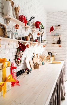 Interior light grey kitchen and red christmas decor. Festive kitchen in Christmas decorations