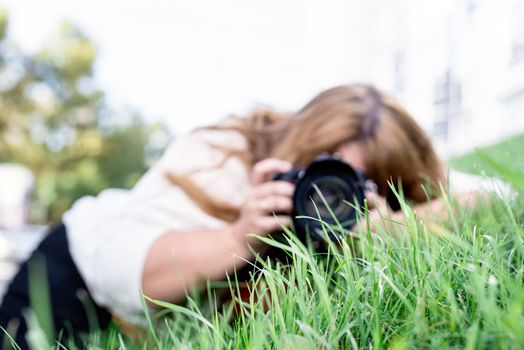 Body positive. Portrait of overweight woman taking pictures with a camera in the park